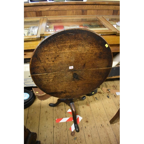 1761 - An antique oak circular tilt top tripod table, 65cm diameter.