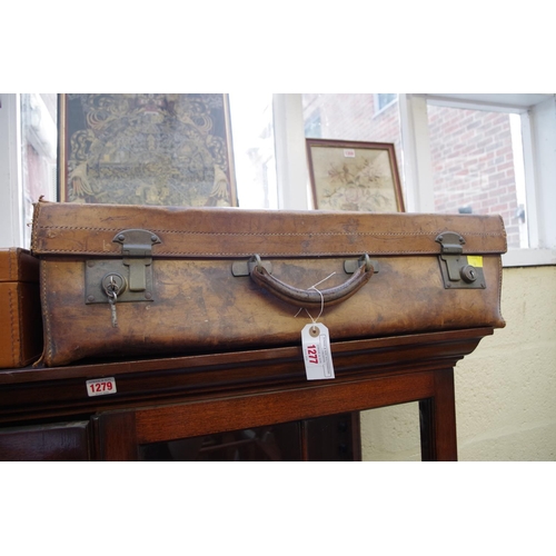 1277 - An old leather suitcase, locked, 65cm wide.