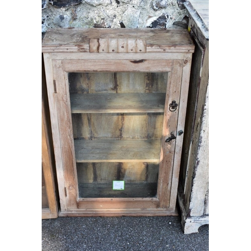 1001 - A painted wood two door cupboard, 103cm wide; together with a stripped pine glazed two door cupboard... 