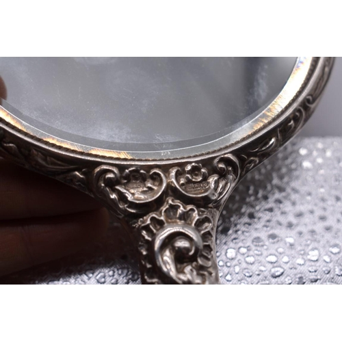 150 - A four piece silver embossed dressing table set, by W I Broadway & Co, Birmingham 1963.... 