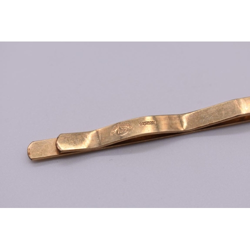199 - A gold tie clip, hallmarked 375, 7g; together with a rolled gold example. (2)