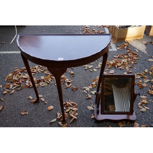 1084 - A mahogany pie crust half moon table, 73cm wide; together with a mahogany dressing mirror.This lot c... 