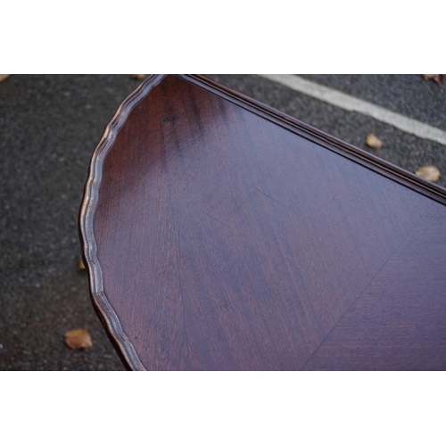 1084 - A mahogany pie crust half moon table, 73cm wide; together with a mahogany dressing mirror.This lot c... 