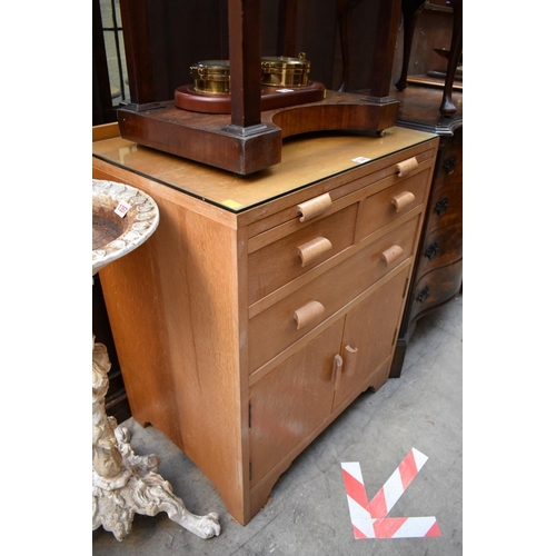 1348 - A pale oak side cabinet, in the Heal's style, 63cm wide.