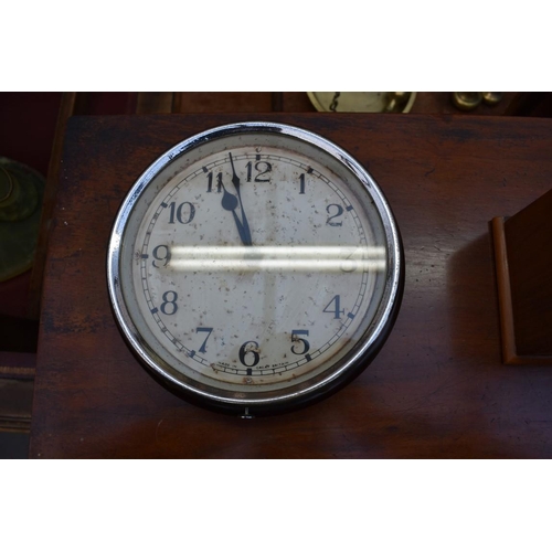 1349 - A collection of four various clocks and timepieces, to include a 1930s walnut dome top example ... 