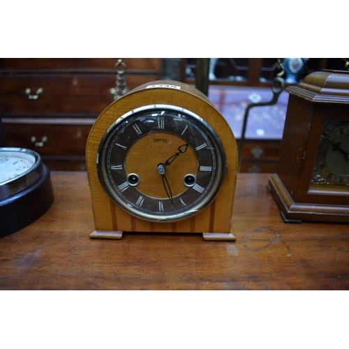 1349 - A collection of four various clocks and timepieces, to include a 1930s walnut dome top example ... 