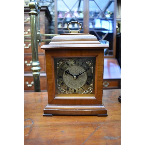 1349 - A collection of four various clocks and timepieces, to include a 1930s walnut dome top example ... 