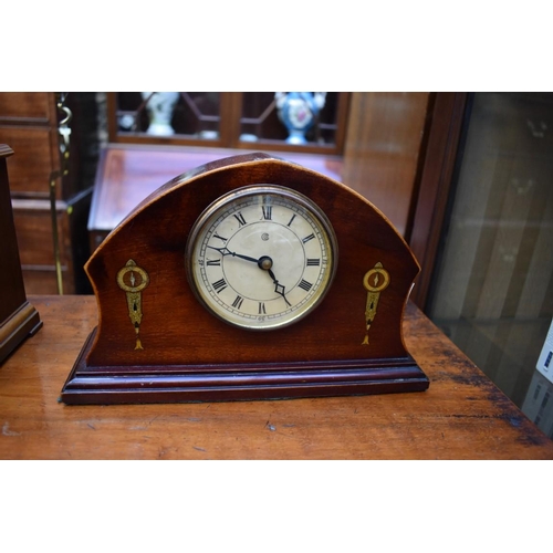 1349 - A collection of four various clocks and timepieces, to include a 1930s walnut dome top example ... 