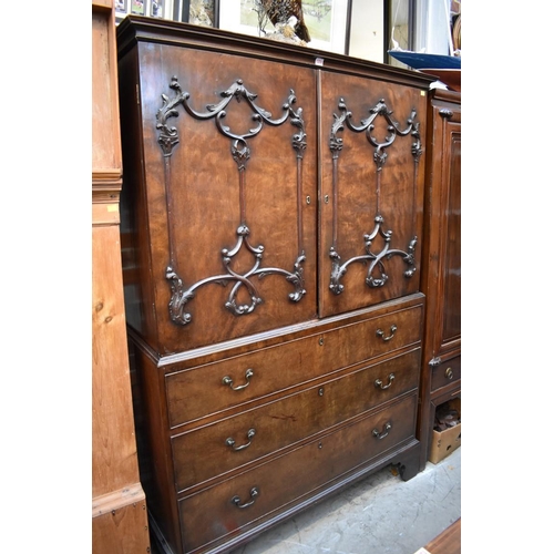 1374 - A George III mahogany linen press, in the manner of William Vile, the pair of relief moulded doors e... 