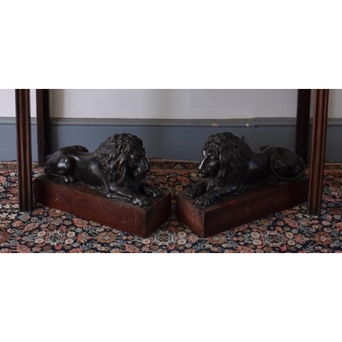 1862 - (THH) A large and impressive pair of bronze recumbent lions, each on a Breccia marble base, 35.5cm h...
