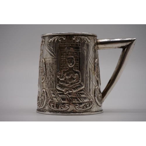 40 - A Malaysian white metal tankard, decorated figure and rhyme, 8cm high.