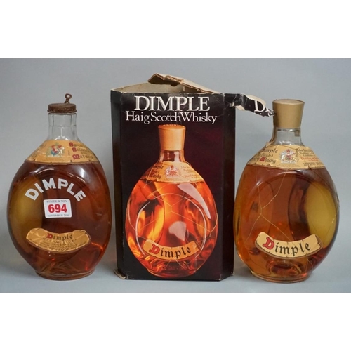 694 - Two old 26 2/3 fl.oz. bottles of Dimple blended whisky, comprising: a 1950s bottling, with spri... 