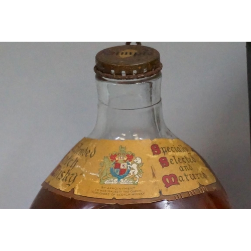 694 - Two old 26 2/3 fl.oz. bottles of Dimple blended whisky, comprising: a 1950s bottling, with spri... 