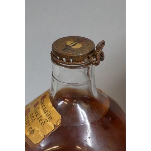 694 - Two old 26 2/3 fl.oz. bottles of Dimple blended whisky, comprising: a 1950s bottling, with spri... 