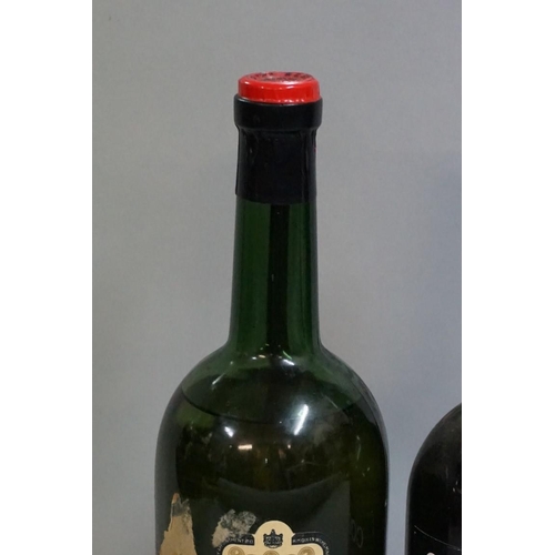 697 - An old bottle of Bolskummel liqueur; together with another old bottle of Cockburn's fine old ru... 