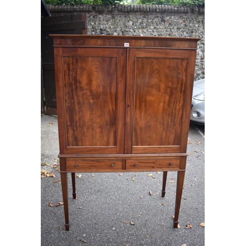 1077 - An antique mahogany cupboard having pair of doors and two small drawers, 101cm wide, (converted to m... 