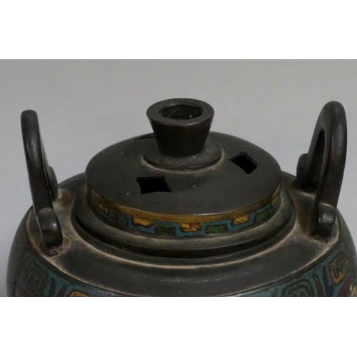 1551 - A Chinese bronze and cloisonne enamel twin handled tripod censer and cover, Qing, 17cm high.... 