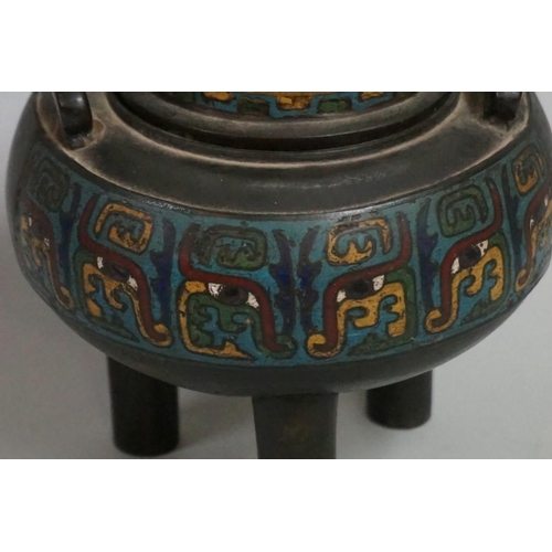 1551 - A Chinese bronze and cloisonne enamel twin handled tripod censer and cover, Qing, 17cm high.... 