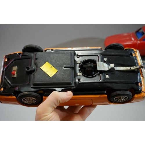 527 - Two vintage tin plate battery operated cars, comprising: a Taiyo Chevrolet Camaro, boxed; and anothe... 