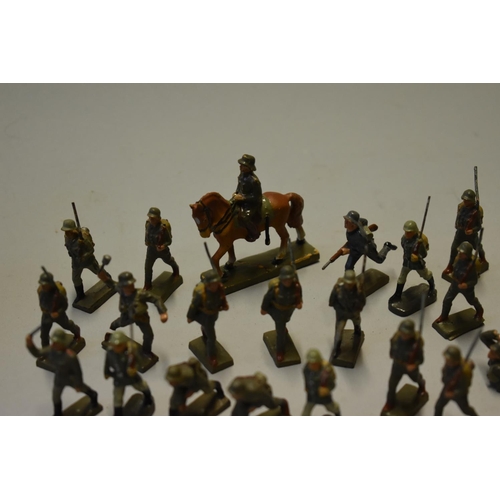 560A - Twenty three Lineol German World War II soldiers, to include a calvary figure, 5.7cm high; in a... 