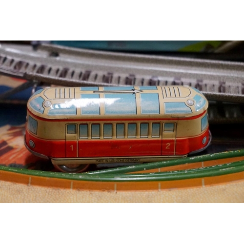 594 - A vintage Technofix 'Mountain Express' tinplate clockwork train set, to include one coach, (no key);... 