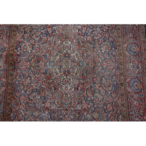 1070 - A Persian rug, having central floral medallion with allover floral design, 189 x 130cm.... 