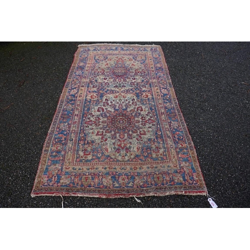 1078 - A Persian rug, having two central medallions with floral borders, 223 x 130cm.