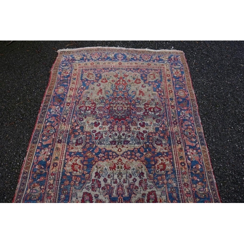 1078 - A Persian rug, having two central medallions with floral borders, 223 x 130cm.