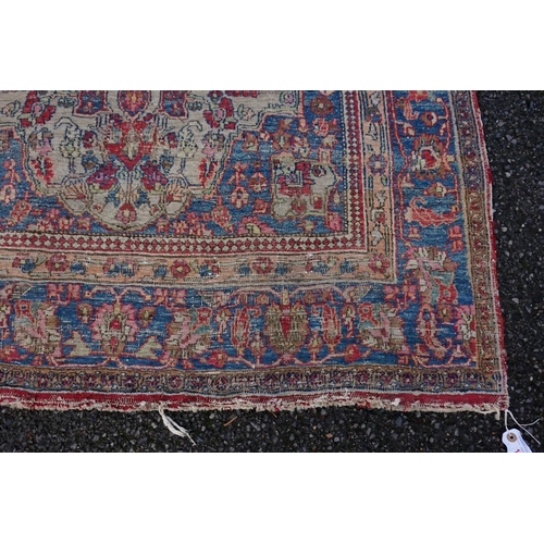 1078 - A Persian rug, having two central medallions with floral borders, 223 x 130cm.