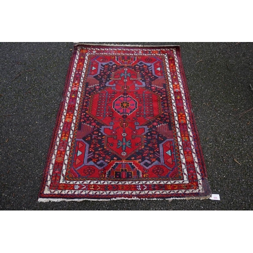 1079 - A Persian rug, having floral borders, 150 x 144cm.