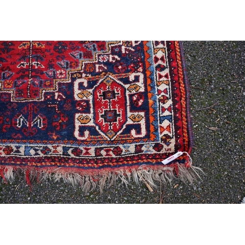 1080 - A small Persian rug, having central medallion with geometric borders, 150 x 112cm.