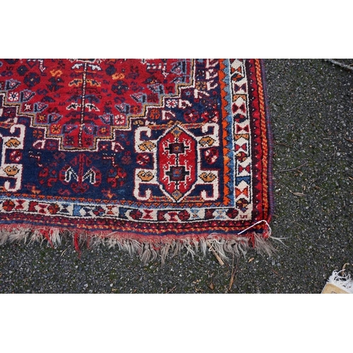 1080 - A small Persian rug, having central medallion with geometric borders, 150 x 112cm.