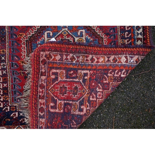 1080 - A small Persian rug, having central medallion with geometric borders, 150 x 112cm.