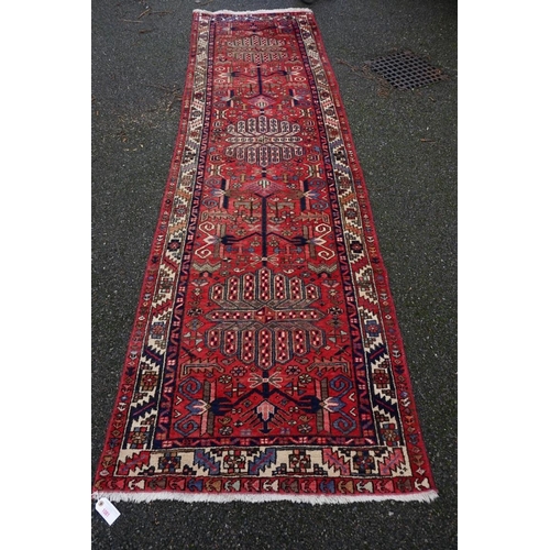 1081 - A large Persian runner, having three central medallions with geometric borders, 330 x 95cm.... 