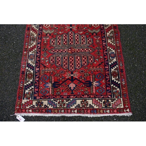 1081 - A large Persian runner, having three central medallions with geometric borders, 330 x 95cm.... 