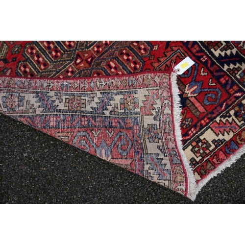 1081 - A large Persian runner, having three central medallions with geometric borders, 330 x 95cm.... 