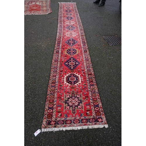 1084 - A large Persian runner, having thirteen central medallions, with allover floral and geometric design... 