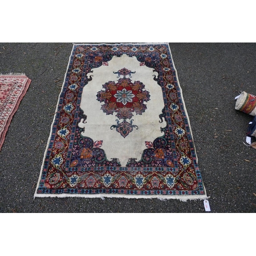 1085 - A Persian rug, having central floral medallion, with floral borders, 190 x 125cm.