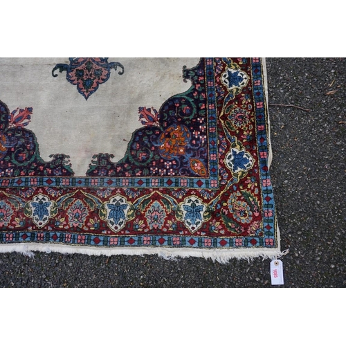 1085 - A Persian rug, having central floral medallion, with floral borders, 190 x 125cm.