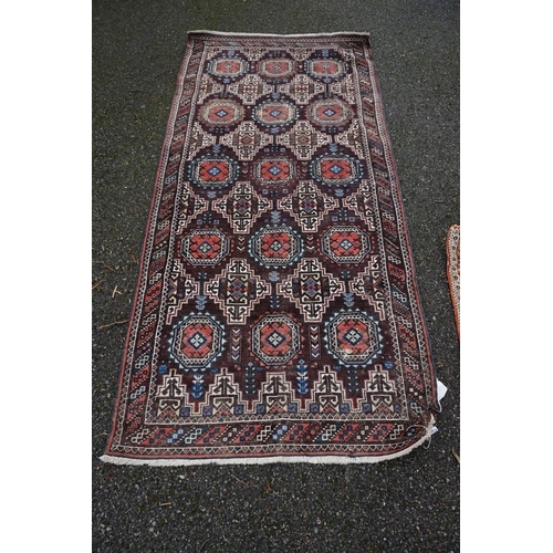 1086 - A Persian rug, having repeated design to central field with geometric borders on a red ground, 202 x... 