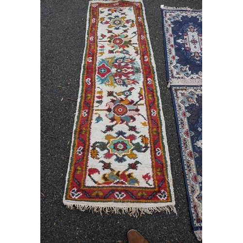 1087 - A Persian runner, 220 x 69cm; together with a pair of small rugs, 108 x 60cm; and a machine made cla... 