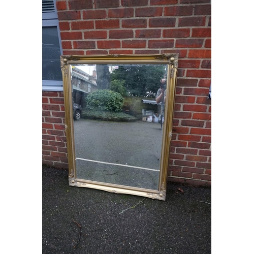 1090 - A large modern gilt framed rectangular wall mirror, 136.5 x 106cm. 