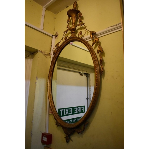 1091 - An old neo-classical style gilt framed oval wall mirror, 127 x 61cm.