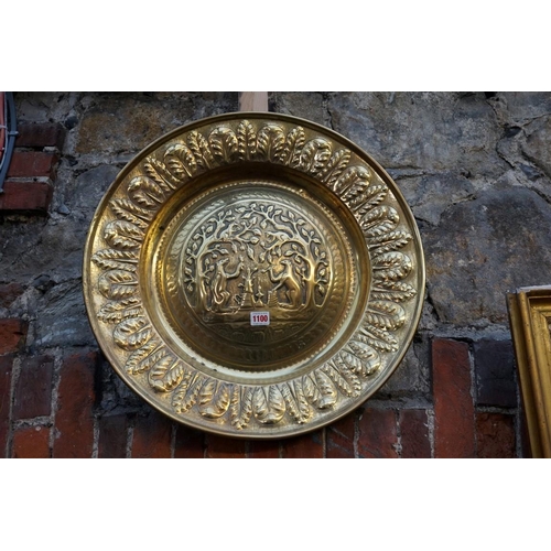 1100 - A 19th century Continental brass alms dish, embossed to the centre with an anthropomorphic scene, th... 