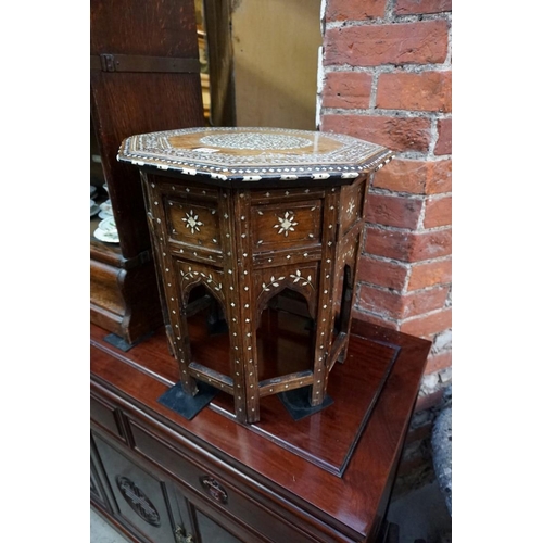 1105 - A Damascus hardwood and bone inlaid octagonal folding table, 41.5cm wide.