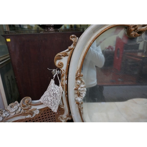 1111 - A Louis XV style grey painted and parcel gilt mirror back dressing table, with marble top and cane d... 