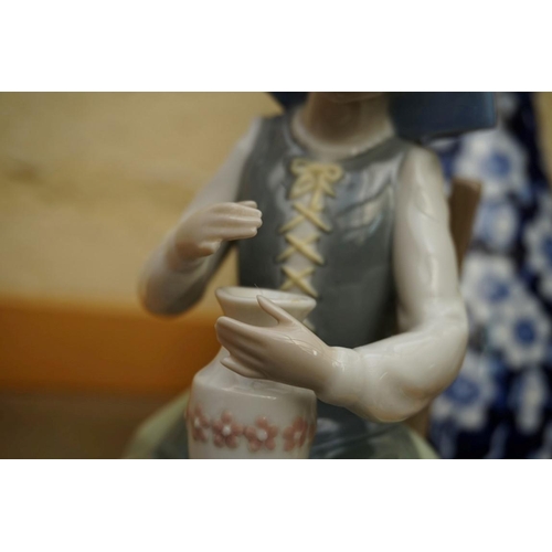 1128 - A small group of pottery and porcelain, to include: a Lladro figure, 21cm high, (chip to little fing... 