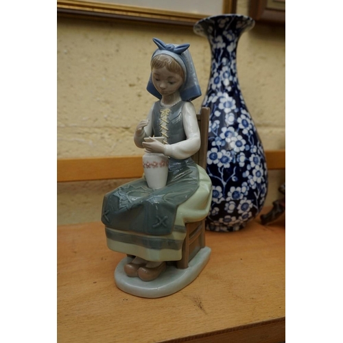 1128 - A small group of pottery and porcelain, to include: a Lladro figure, 21cm high, (chip to little fing... 