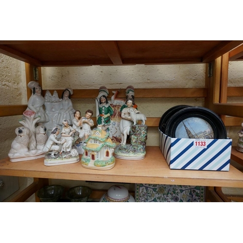 1133 - A small collection of Staffordshire pottery figures, to include: a reproduction spaniel inkwell; and... 