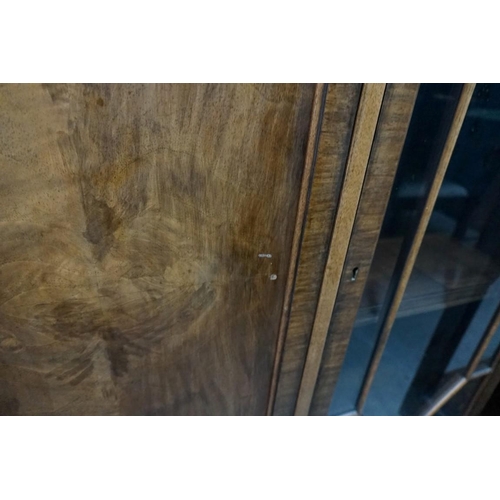 1138 - A 1930s walnut bookcase, 121cm wide.